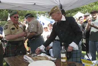 Participants gathered around a table at the Fair Hill Scottish Games
